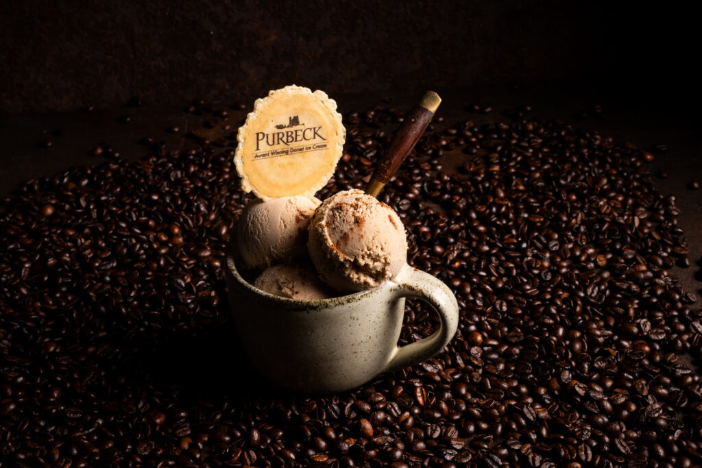 Purbeck ice cream in a mug on top of coffee beans