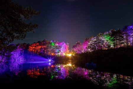 The Blue Pool lit up at night in multicolours
