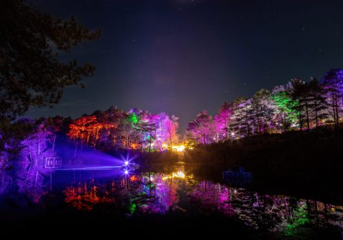 The Blue Pool lit up at night in multicolours